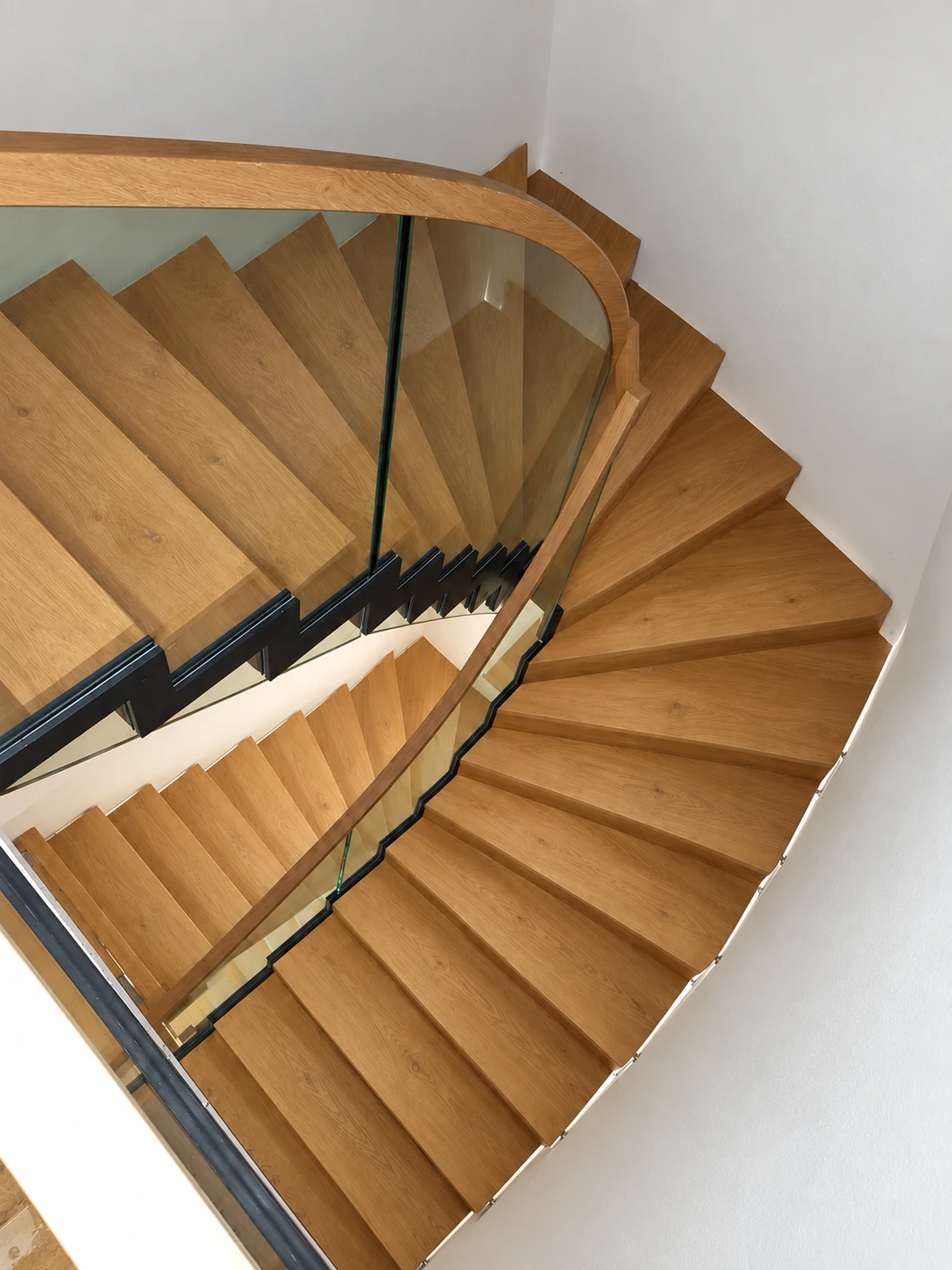 Blick von oben auf die halbgewendelte Faltwerktreppe